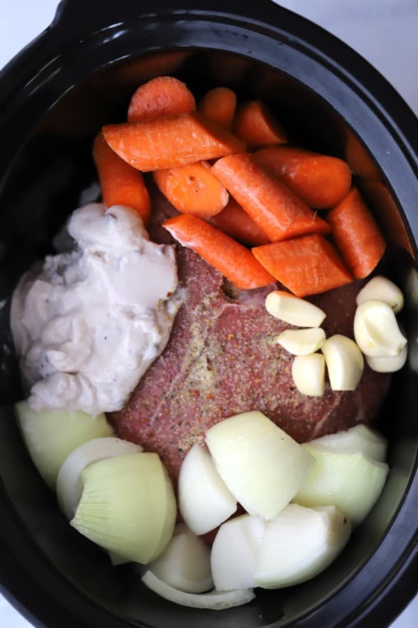 The best slow cooker pot roast recipe made with cream of mushroom soup and veggies.