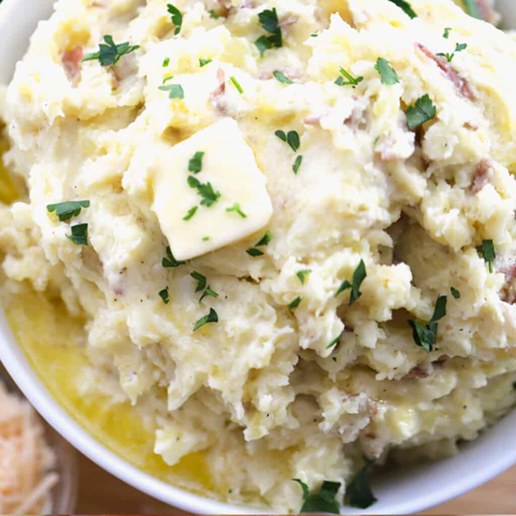 garlic mashed potatoes recipe in a white bowl. best potato side dish.