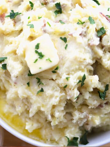 garlic mashed potatoes recipe in a white bowl.