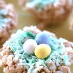 Rice Krispies treat decorated to look like a birds nest, with three chocolate eggs on top.