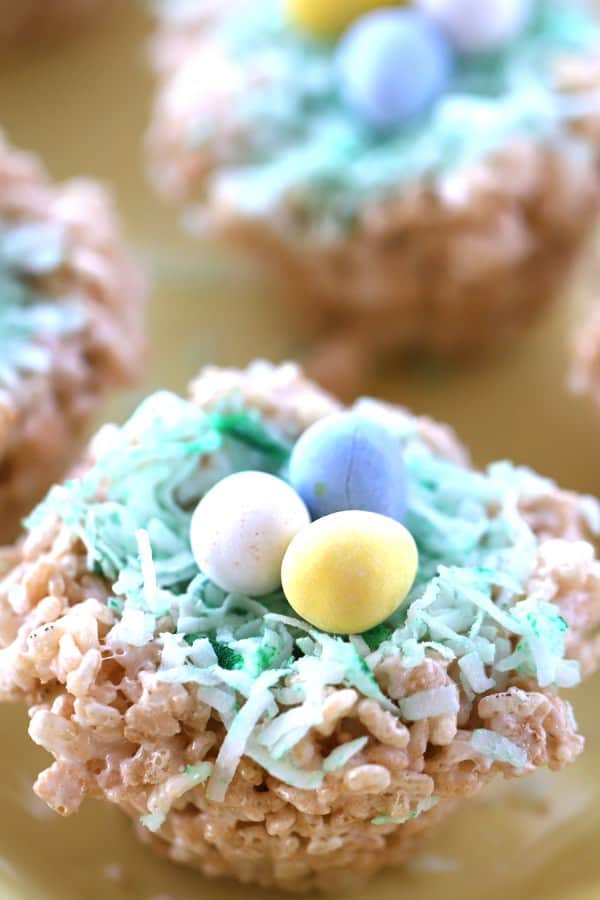 Rice Krispies treat decorated to look like a birds nest, with three chocolate eggs on top. best easter no bake dessert. 