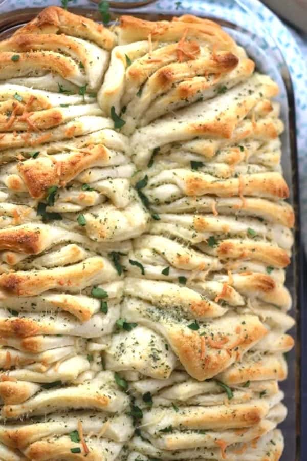 A baking dish full of homemade pull-apart bread spread with Garlic Butter.