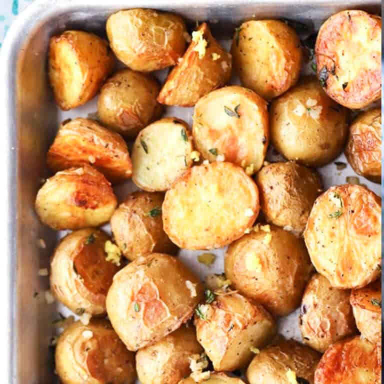 Garlic and Thyme Roasted Potatoes, crispy and chewy and bursting with flavor! boomer gold potatoes, easy oven roasted potatoes.