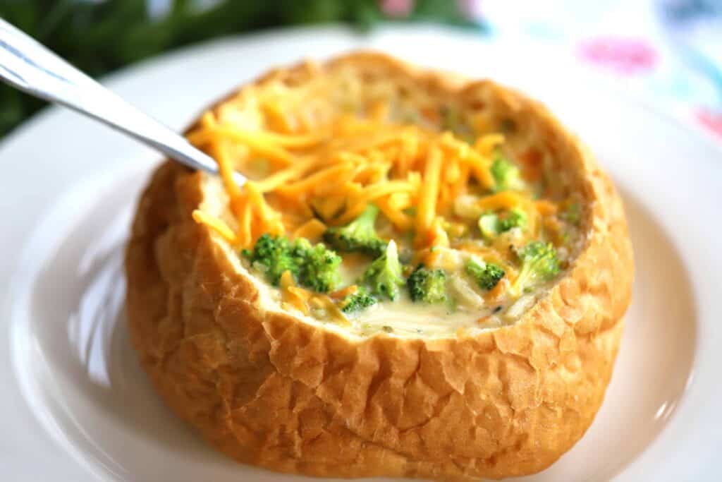 Potato Broccoli Cheese Soup in a bread bowl with a spoon