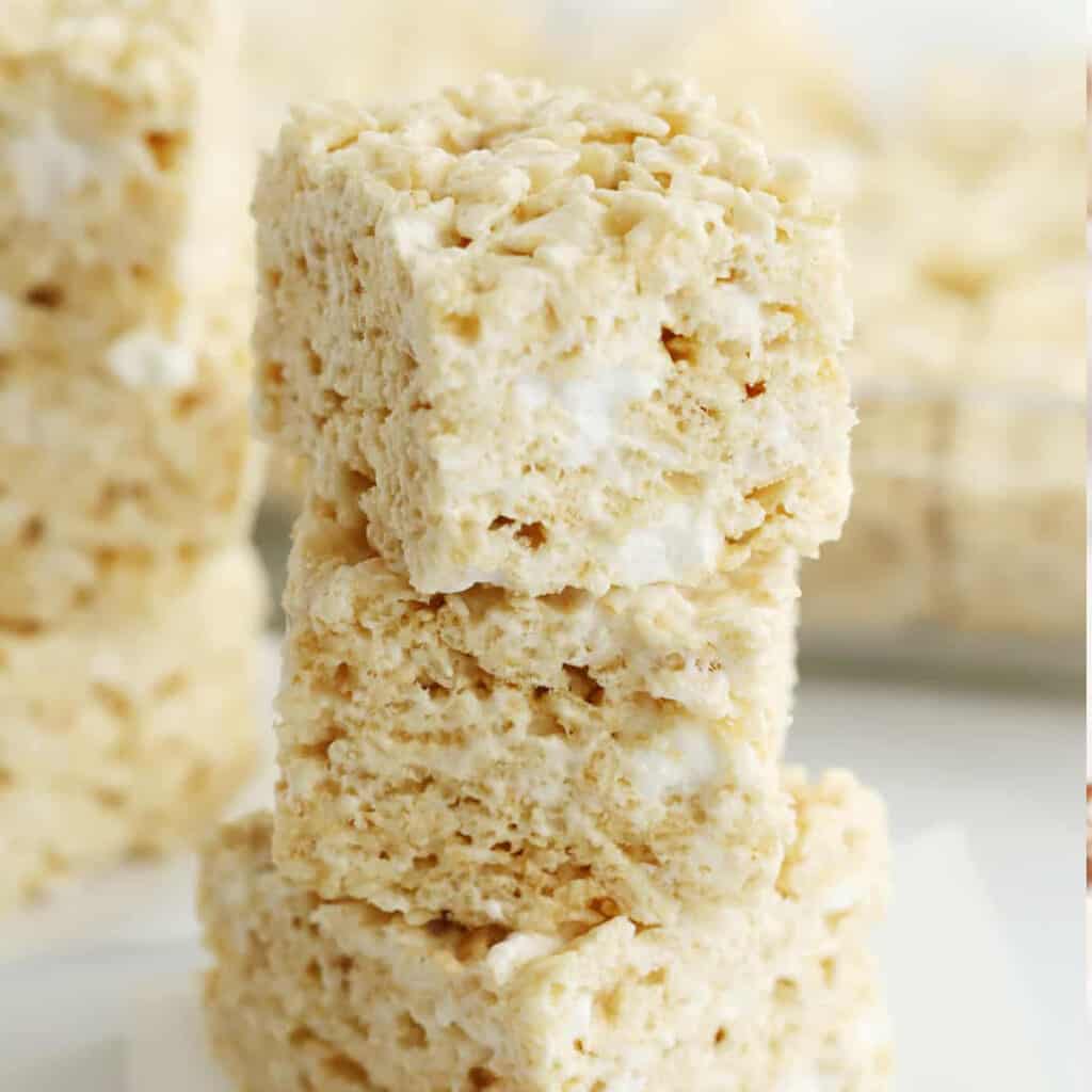 Classic Rice Krispies Treats cut into squares and stacked on top of each other.