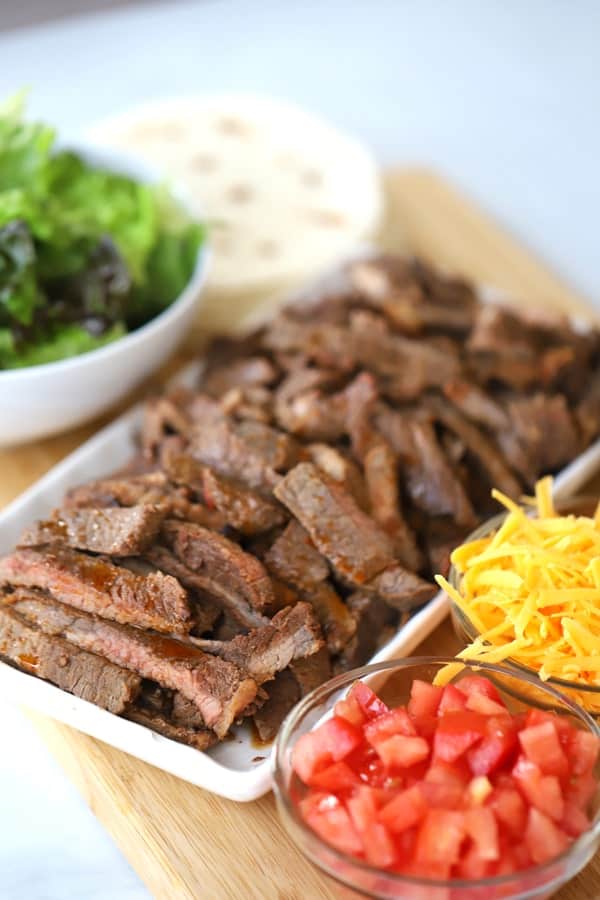 Carne Asada and Taco ingredients on a platter, carne asada burrito recipe, what is carne asada, chipotle carne asada recipe. 