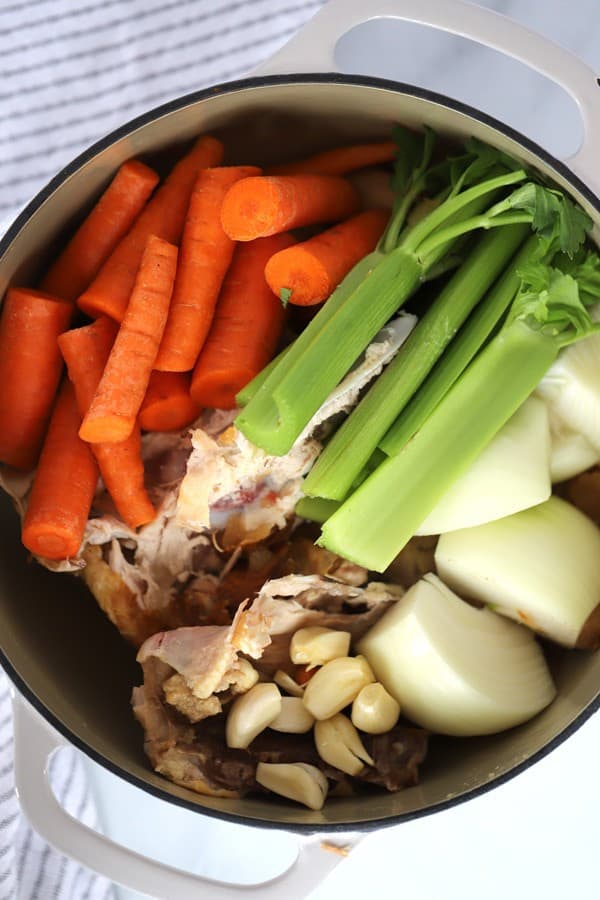 Ingredients to make homemade chicken stock in a large pot.
