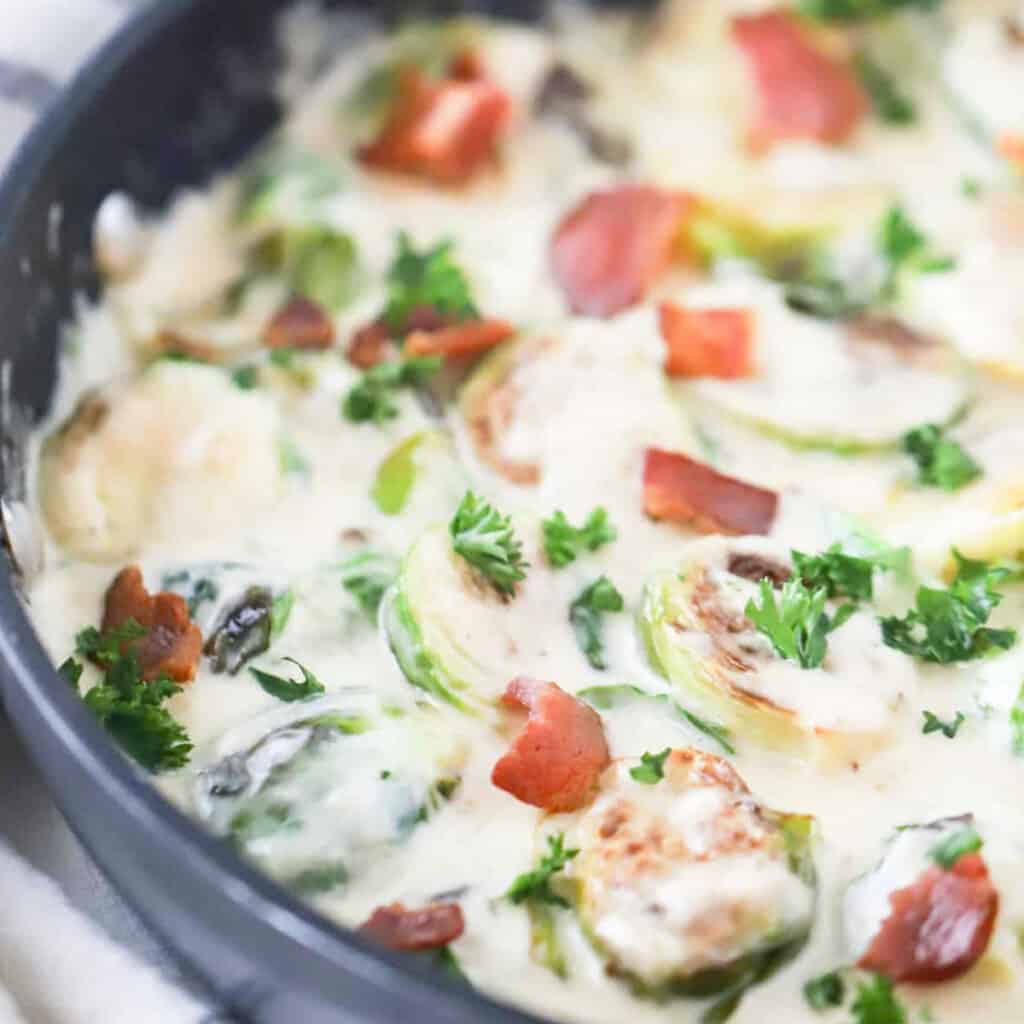 creamy alfredo brussels sprouts with bacon, easy easter side dish, famcy eater side dish. traditional easter dinner, menu ideas for dinner