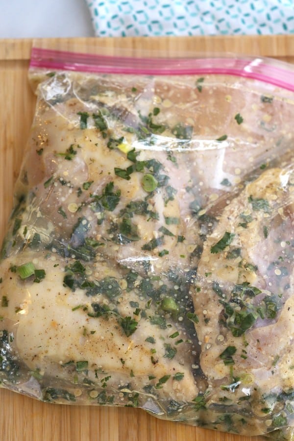 Lime cilantro marinade in a freezer bag with garlic, fresh cilantro, fresh lime juice, and spices. So much flavor packed into this incredible meal!