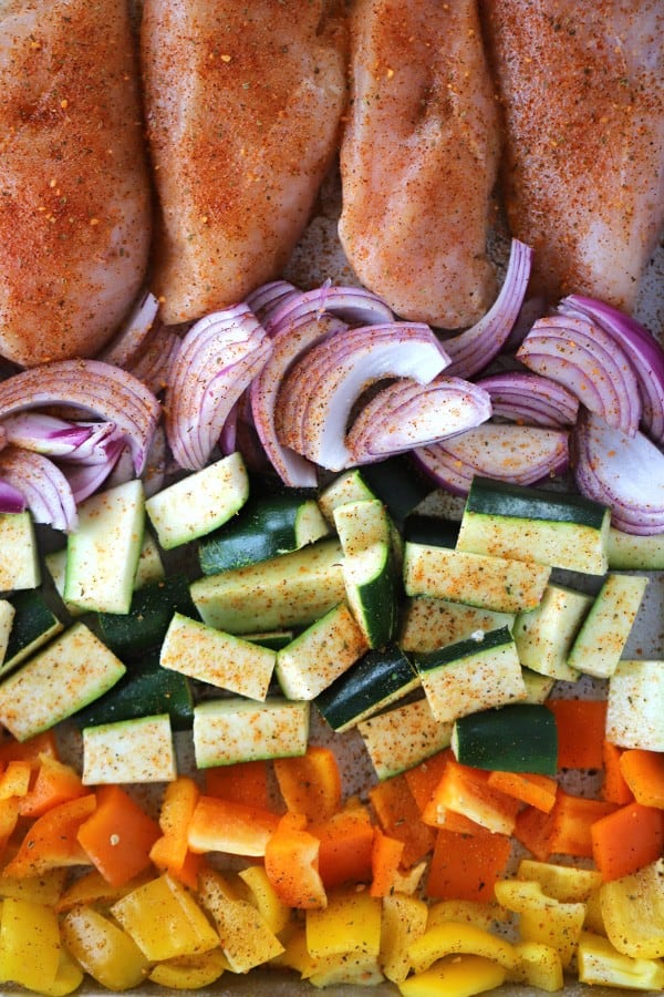 Sheet Pan Chili Lime Chicken and Vegetables ingredients on a sheet pan ready to bake.