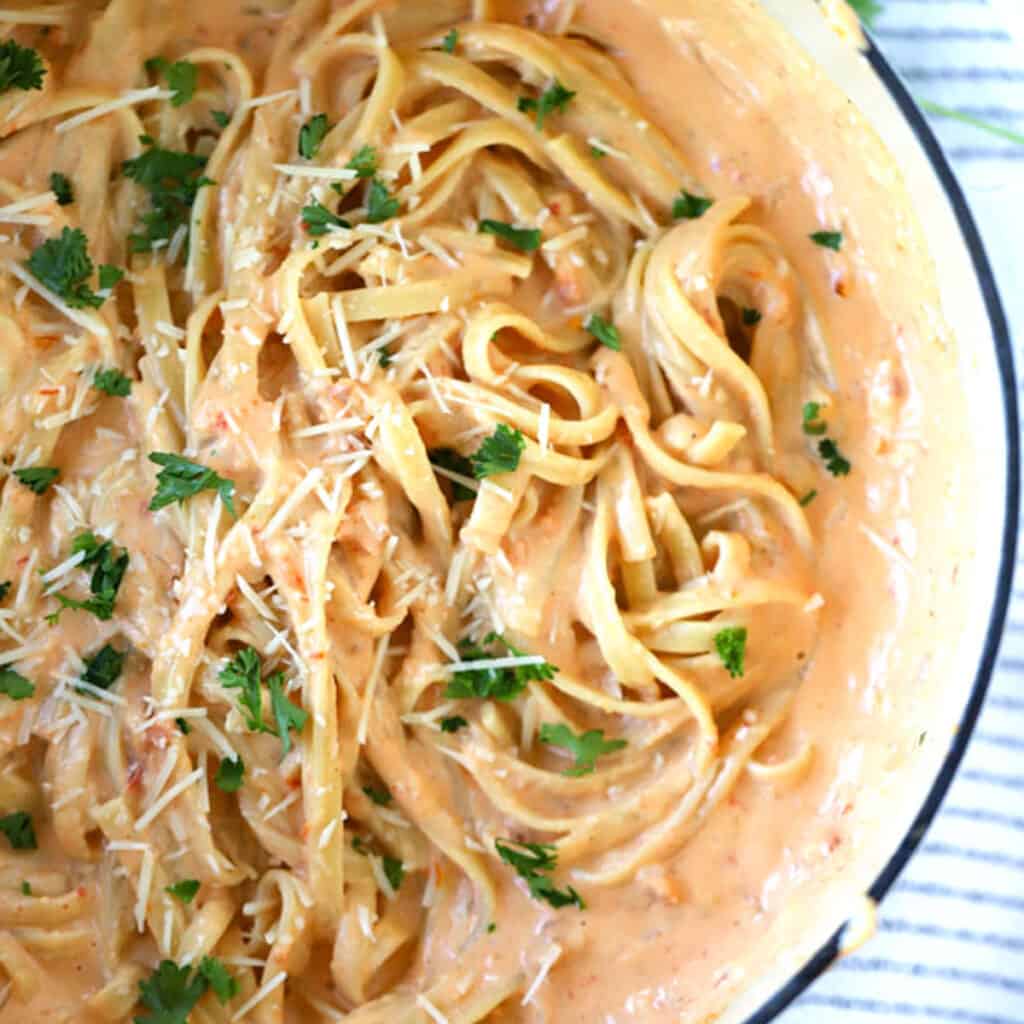 sun dried tomato alfredo fettucini in a large pot