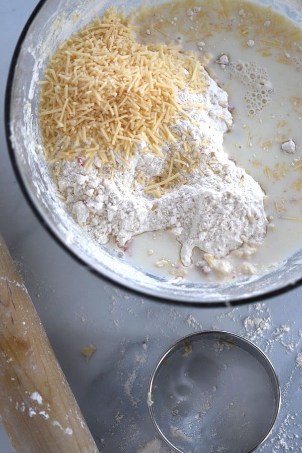 Dry biscuit ingredients in a bowl to make savory biscuits with sun-dried tomatoes and parmesan cheese.