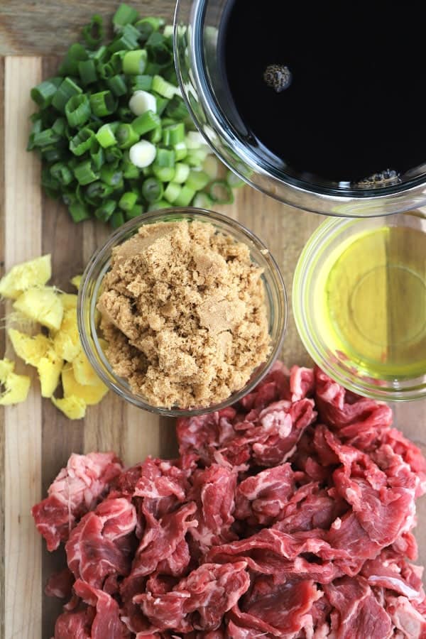 Ingredients for Beef  teriyaki marinade  with Broccoli stir fry on a wood cutting board