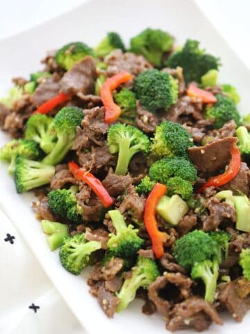 Homemade Teriyaki marinade for easy teriyaki beef and broccoli stir fry on a white plate served with rice