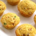 These Ham and Cheese Cornmeal Muffins have little bits of ham, sharp cheddar, and thinly sliced green onions. These cornmeal muffins are the perfect side to a bowl of soup or warmed up for breakfast with a little slab of butter!