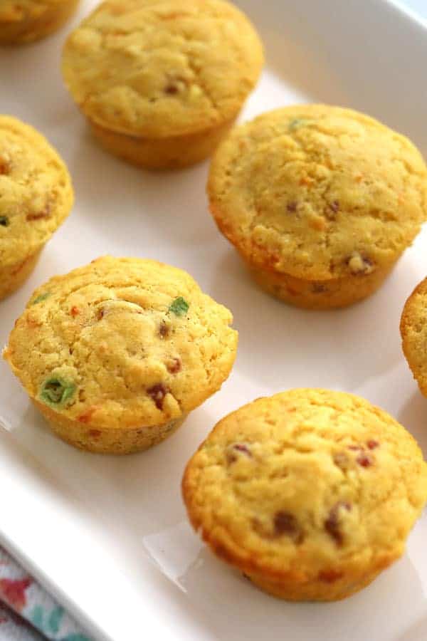 These Ham and Cheese Cornmeal Muffins have little bits of ham, sharp cheddar, and thinly sliced green onions. These cornmeal muffins are the perfect side to a bowl of soup or warmed up for breakfast with a little slab of butter!