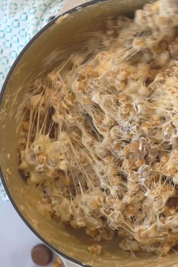 Mixing Reese's Peanut Butter Cereal Bars in a pot.