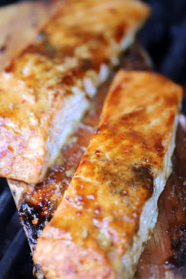 Grilled Teriyaki Salmon Recipe on a cedar plank with teriyaki salmon glaze over the top.