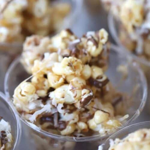 Coconut caramel popcorn balls with a chocolate drizzle