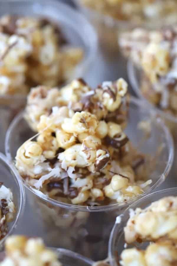 Coconut caramel popcorn balls with a chocolate drizzle
