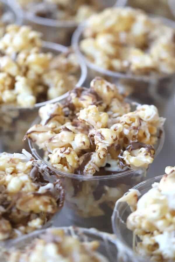 Coconut caramel popcorn in small party cups.