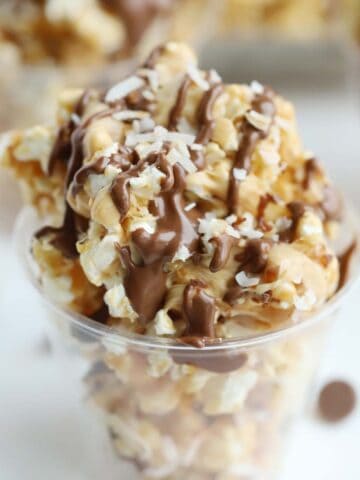 Coconut caramel popcorn balls with a chocolate drizzle