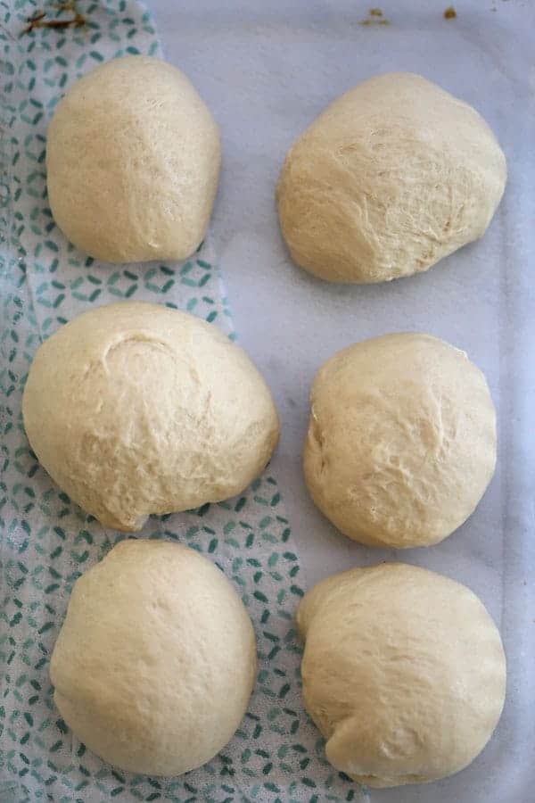Six small balls of pizza dough on a cloth. Pizza dough for grilling.