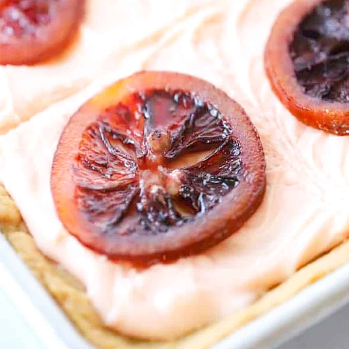 Sugar cookie bars with blood orange cream cheese frosting and candied blood oranges