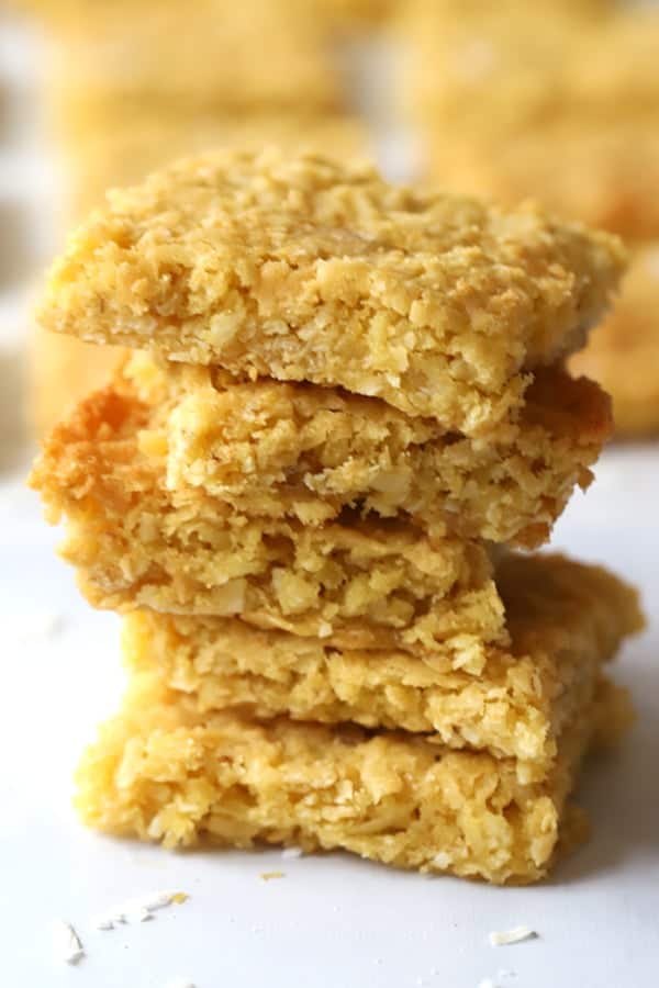 Coconut cookie bars stacked on top of each other.