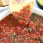 how to make salsa. Salsa in a serving bowl with tortilla chip