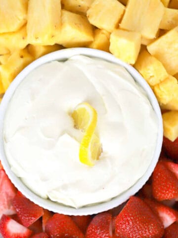lemon Cheesecake Fruit dip on a platter wiith fresh strawberries and pineapple, best dip for fruit.fruit dip cream cheese.