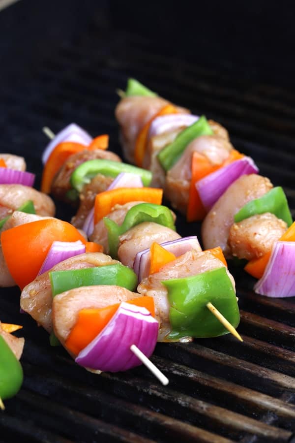 chicken kabobs on the grill with peppers and onions