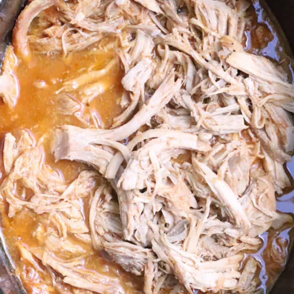 sweet pork cooked and shredded in a slow cooker