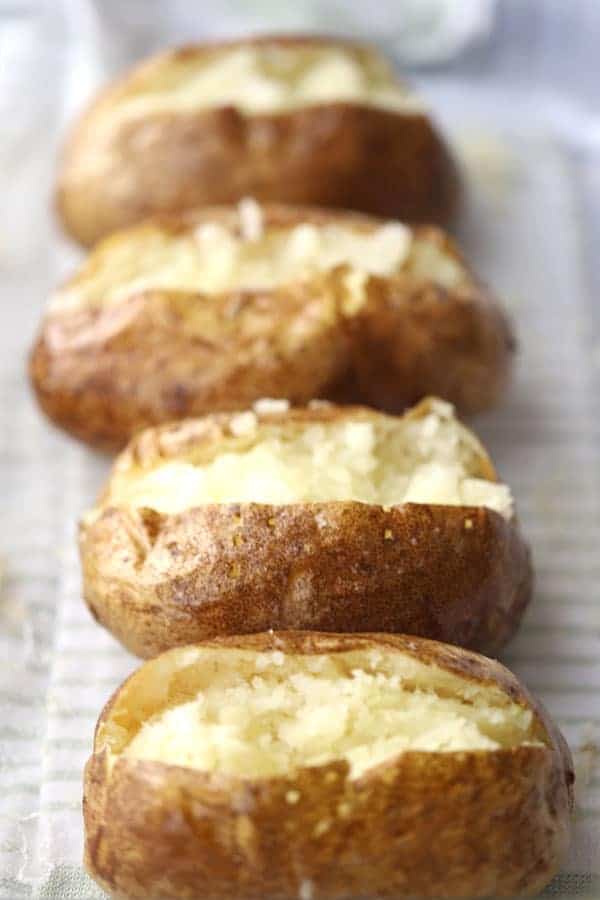baked, baked potato in oven in a glass baking dish