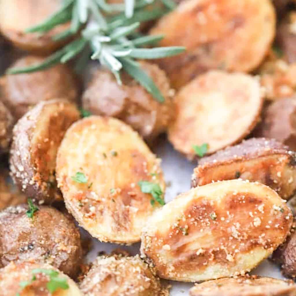 Rosemary and Parmesan Fingerling Potatoes on a baking sheet. Dinner ideas for Valentine's Day.