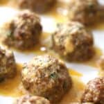 italian meatballs on a baking sheet