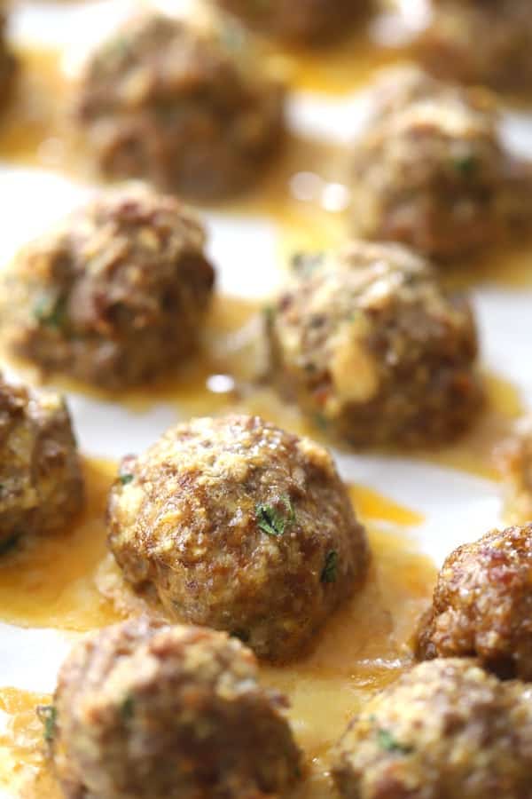 italian meatballs on a baking sheet