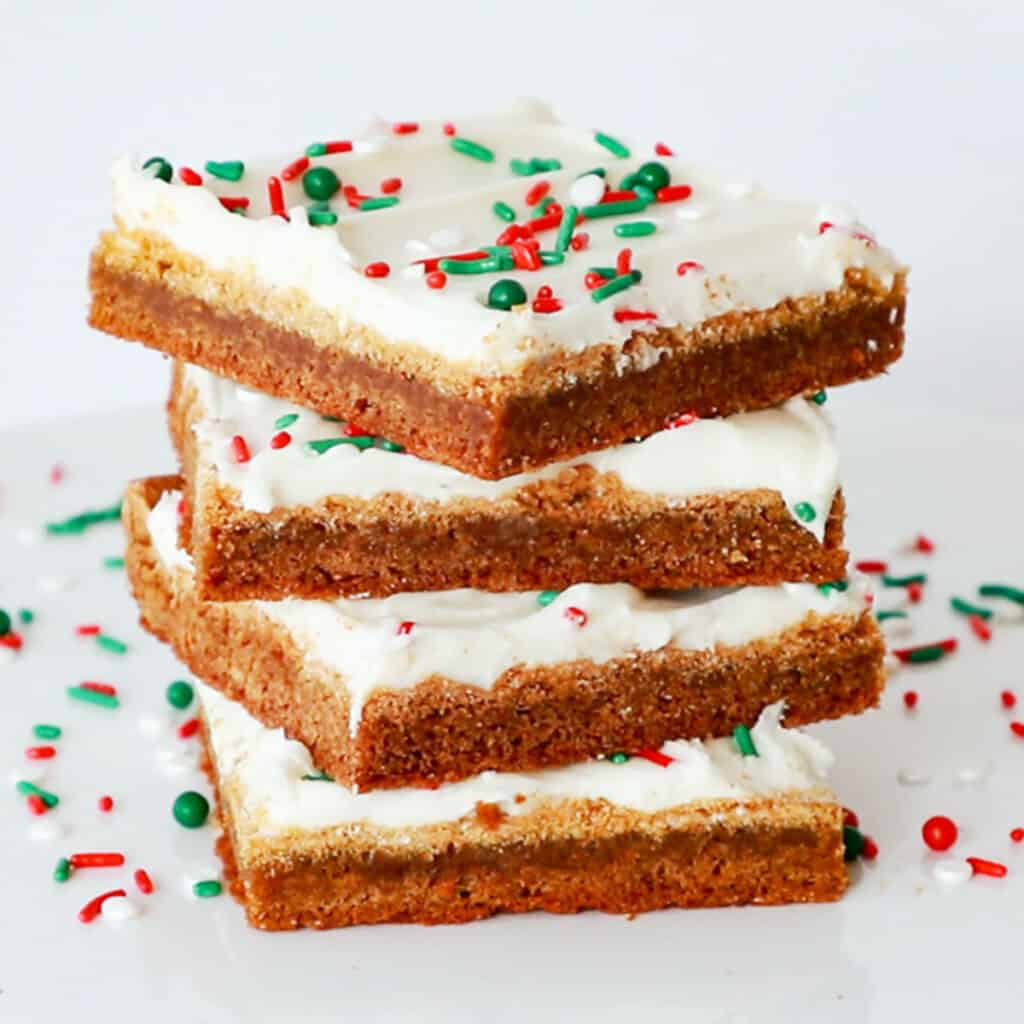 Gingerbread cookie bars with red and green sprinkles, spiced gingerbread, christmas gingerbread recipes, gingerbread cookie recipes.
