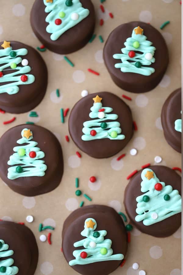 mint chocolate covered Oreos, decorated with sprinkles and icing for christmas. 