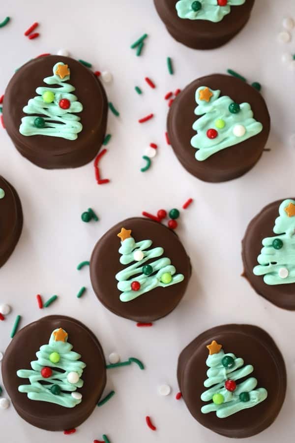 Oreos dipped in mint chocolate and decorated with Christmas trees.