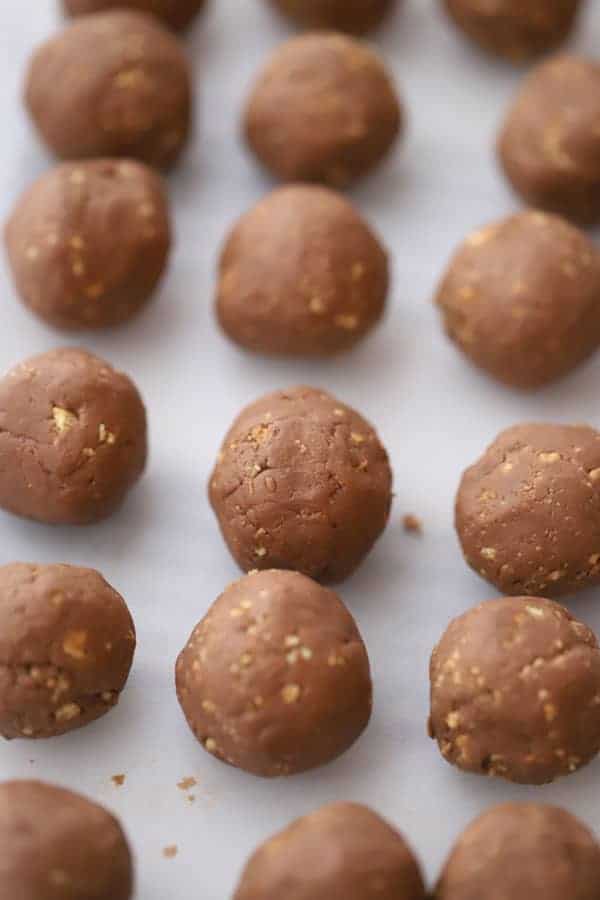 Nutella balls, ready to cover in chocolate on a baking sheet