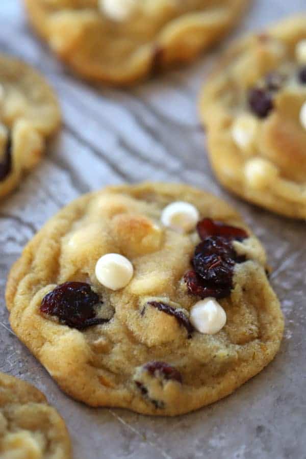 Orange Cranberry Cookies with white chocolate chips on a baking sheet.