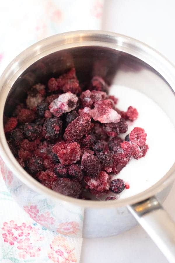 berry syrup ingredients in a saucepan