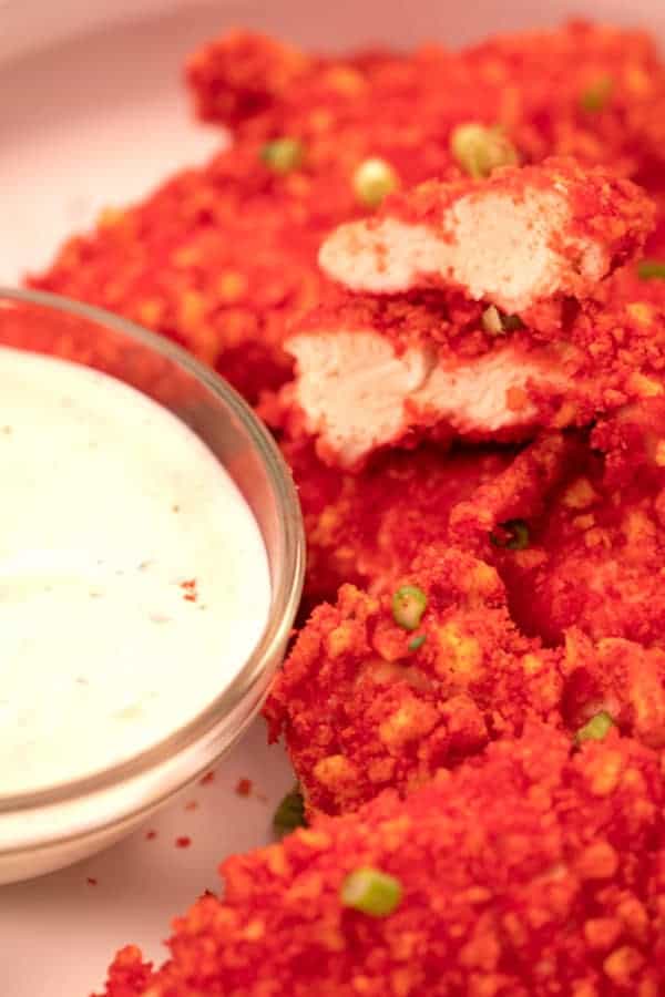 flaming hot cheeto chicken tenders on a platter with ranch dressing