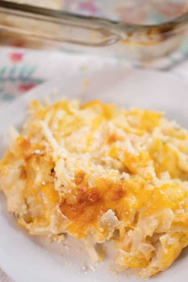 one of the best cheesy potato casseroles, served on a white plate, best cheesy potatoes recipe.