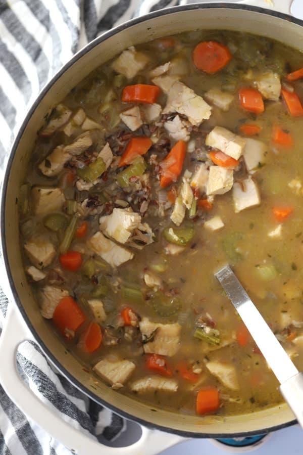 A large stock pot filled with Turkey and Rice Soup.