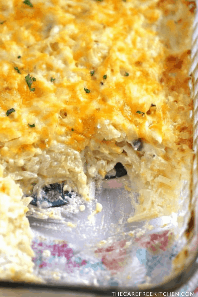 cheesy potato casserole in a glass baking dish, an easy cheesy potato recipe. 