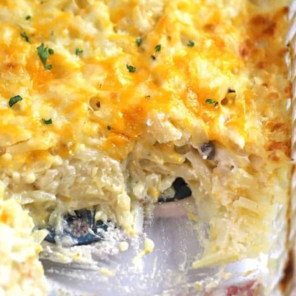 cheesy potato casserole in a glass baking dish, an easy cheesy potato recipe