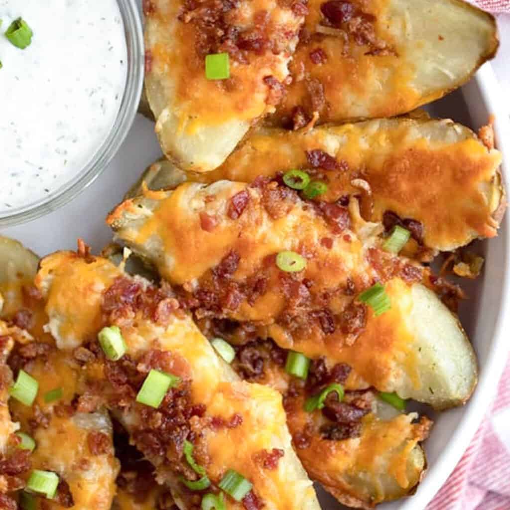 loaded baked potato skins recipe with cheese and bacon, easy baked potato skins recipe, game day menu ideas.