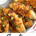 how to make best potato skins appetizer, smothered in cheese, bacon and green onions.
